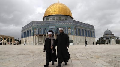 Palestinians walk outside the Dome of the Rock in Jerusalem's Old City in Al Aqsa mosque compound on January 23, 2018. Ahmad Gharabli / AFP PHOTO