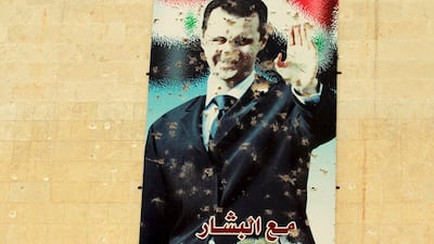 A damaged picture of Syrian president Bashar Al Assad is seen on a wall in Syrian town of Idlib. Ammar Abdallah / Reuters