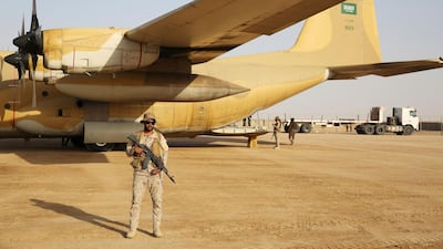 A Saudi soldier guards an aid plane at an air base in Marib, Yemen. A multi-million dollar agreement was signed between the refugee agency UNHCR and the King Salman Humanitarian Aid and Relief Centre in support of Yemen's internally displaced persons. Jon Gambrell / AP