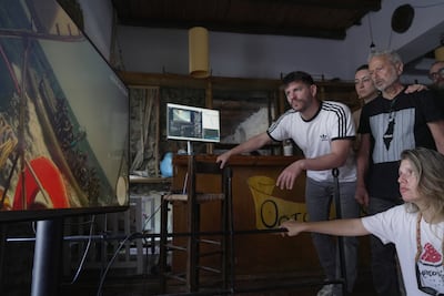 Gaza flotilla activists monitoring video transmissions from their ships watch the interception of one of the group's boats in international waters. Reuters