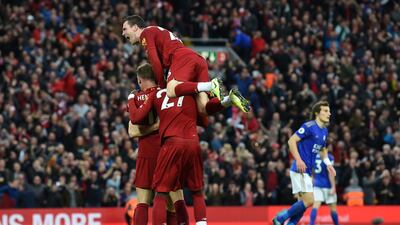 Liverpool's James Milner celebrates with teammates after taking a penalty and scoring his team's second goal. AFP