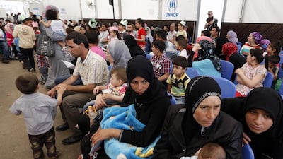 Syrian refugees wait to be registered at a UNHCR centre in the Lebanese port city of Tripoli. Anwar Amro / AFP / May 29, 2014