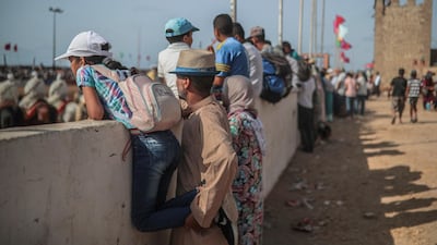 People watch Tabourida, a traditional horse riding show also known as Fantasia, in the coastal town of El Jadida, Morocco.