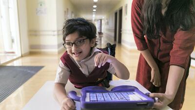 Zahra, a pupilat Al Noor Training Centre for Children With Special Needs, communicates using her Sound Flex Communication App. Reem Mohammed / The National