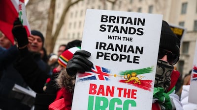 A demonstrator holds up a placard at a rally in London in solidarity with protesters in Iran. Getty
