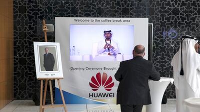 ABU DHABI, UNITED ARAB EMIRATES, Nov. 10, 2014: A visitor talkes a coffee break while watching (C) HE Suhail Mohamed al Mazrouei, the UAE Minister of Energy, as he talks during a panel at the Abu Dhabi International Petroleum Exhibition & Conference (ADIPEC) on Monday, Nov. 10, 2014, at the Abu Dhabi National Exhibition Center. (Silvia Razgova / The National)Usage: Nov. 10, 2014Section: BIZReporter: Leanne Graves, Anthony McAuley, Dania Saadi