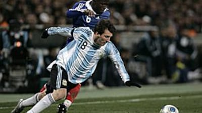 Argentina's Lionel Messi, front, stumbles past Lassana Diarra at the Stade Velodrome.