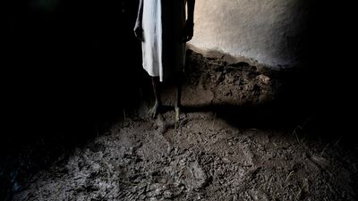 A woman stands in her house in Dijeri. The village was flooded for a week in September after the River Luri burst its banks.