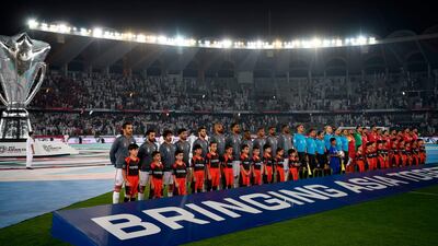 Players stand on the pitch prior to the game between United Arab Emirates and Bahrain. AFP