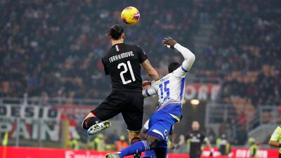 AC Milan's Zlatan Ibahimovic jumps for the ball with Omar Colley of Sampdoria. AP