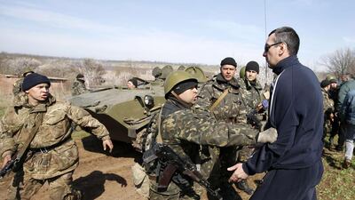 Ukrainian soldiers clash with pro-Russia protesters on the field near Kramatorsk, in eastern Ukraine. Ukrainian forces tightened their grip on the eastern town of Kramatorsk on Wednesday. Marko Djurica / Reuters