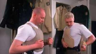 German police officers put on their equipment and uniform before their shift.