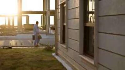A contractor walks past homes of the American Village, Erbil, Iraqi Kurdistan.