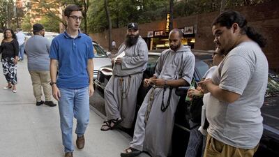 Franciscan friars greet attendees before The Catholic Underground event at the Church of Our Lady of Good Counsel in New York. The Catholic Underground is a celebration of prayer and music run by the Franciscan Friars of the Renewal in New York. Brendan McDermid / Reuters