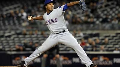 Neftali Feliz of the Texas Rangers pitches against the New York Yankees.
