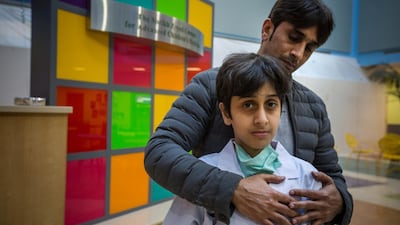 11-year-old Emirati boy Mohammed Al Aryani, with his dad Saif, at the Sheikh Zayed Campus for Advanced Children’s Medicine. Mohammed has Spina Bifida and previously has never walked without crutches. In December, doctors were finally able to operate.