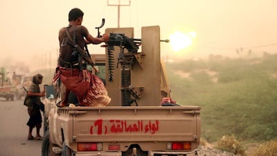A member of the Yemeni government forces fires a heavy machine gun during an offensive against Houthi positions on the outskirts of Hodeidah on June 14. Najeeb Al Mahboobi / EPA