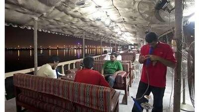 Customers can enjoy views of the creek and the distant lights of the Julfar Towers.