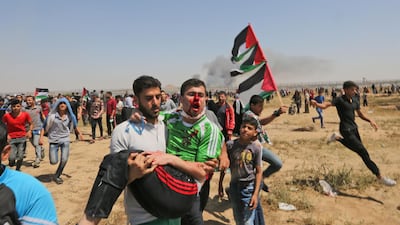 A wounded Palestinian demonstrator is carried away from the border fence during clashes with Israeli forces east of Gaza City in the Gaza Strip. AFP