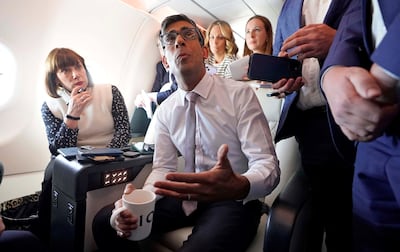 British Prime Minister Rishi Sunak addresses media on a government plane as he heads to Washington. Reuters