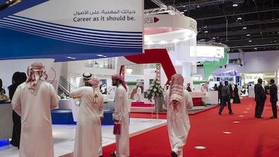 Visitors to this year’s Tawdheef job exhibition for UAE nationals at Adnec make their way around the stalls. A bigger Emirati presence in the private sector is a Government goal. Mona Al-Marzooqi / The National