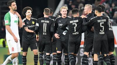 Dortmund forward Erling Braut Haaland is congratulated by teammates after he scored his second goal. AFP