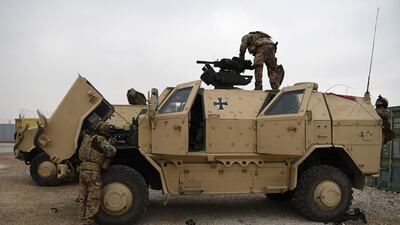 German troops work on a military vehicle at the Camp Marmal base in Afghanistan. AFP