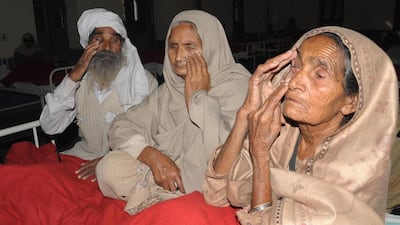 Indian patients Gurbachan Singh, left, Sampuran Kaur, centre. and Pooro Kaur, who lost their eyesight after undergoing surgery at an eye camp, show their damaged eyes at a government hospital in Amritsar. Narinder Nanu / AFP Photo