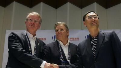 Bernard Lapasset (L), chairman of World Rugby, Brett Gosper (C), CEO of World Rugby and Zhang Dazhong of Alisports (R) pose for a photo at a press conference on Sunday. Isaac Lawrence / AFP / April 10, 2016