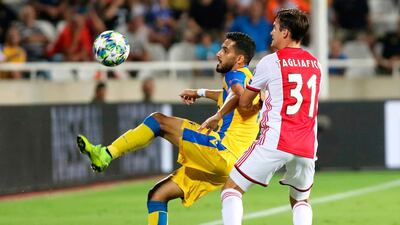 APOEL midfielder Musa Suliman is marked by Ajax defender Nicolas Tagliafico. AFP