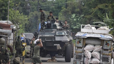 Soldiers prepare for deployment on the outskirts of Marawi city, southern Philippines on June 9, 2017. Muslim militants have laid siege to the city and 13 marines have been killed in fierce fighting. Aaron Favila / AP