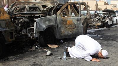 The man prays at the site of a suicide bombing that targeted the Shiite Al Anoud mosque in the Saudi coastal city of Dammam. AFP