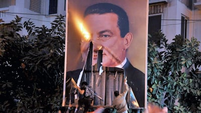 Egyptian protesters tear down a poster of President Hosni Mubarak in 2011, but Islamist parties did not replace him. (Ahmed Youssef / EPA)