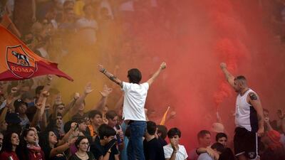 AS Roma fans cheer on the club during their Serie A victory over Chievo on Saturday in Rome. Filippo Monteforte / AFP / October 18, 2014