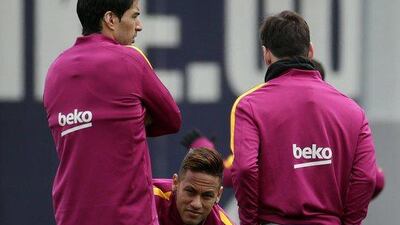 Neymar, centre, chats with his teammates Luis Suarez, left, and Lionel Messi. Alberto Estevez / EPA