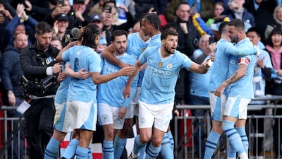 Bernardo Silva is mobbed by teammates after scoring the only goal of the game as Manchester City beat Chelsea at Wembley Stadium in London, on April 20, 2024. Getty Images