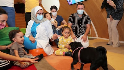 Children meeting Millie the Pug during the arts and crafts session held at Al Jalila Children's Speciality Hospital in Dubai on October 10, 2021. Pawan Singh/The National.
