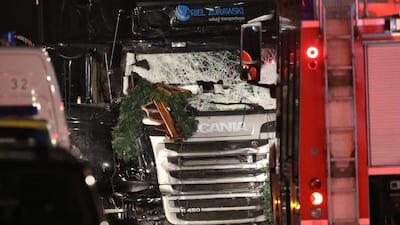 Workers and security inspect the damaged lorry after it ploughed through a Christmas market on December 19 in Berlin, Germany. Sean Gallup / Getty Images