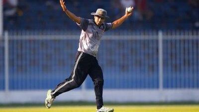 Khurram Khan of the UAE celebrates catching a shot of Gyanendra Malla of Nepal.