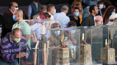 Statues and funerary masks on display during the unveiling of an ancient treasure trove of more than a 100 intact sarcophagi. AFP
