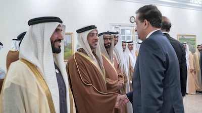 ISLAMABAD, PAKISTAN - January 06, 2019: HH Sheikh Mansour bin Zayed Al Nahyan, UAE Deputy Prime Minister and Minister of Presidential Affairs (2nd L), greets a guest during a reception at the Prime Minister's residence. Seen with HH Sheikh Nahyan Bin Zayed Al Nahyan, Chairman of the Board of Trustees of Zayed bin Sultan Al Nahyan Charitable and Humanitarian Foundation (L). ( Mohammed Al Hammadi / Ministry of Presidential Affairs ) ---