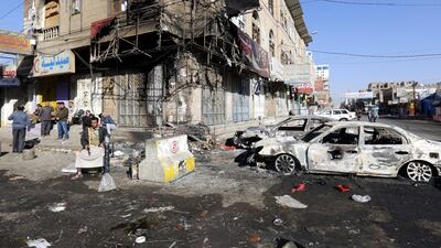 Yemenis gather near destroyed vehicles at a street leading to the residence of Yemen’s ex-president Ali Abdullah Saleh a day after Houthi militants killed him, in Sana’a, Yemen. Yahya Arhab / EPA