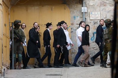 Soldiers stand guard during a weekly settlers' tour of Hebron in the Israeli-occupied West Bank on February 14, 2026. Reuters