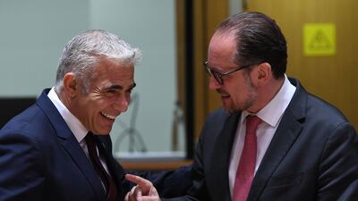 Israeli Minister of Foreign Affairs Yair Lapid, left, talks with Austrian Foreign Minister Alexander Schallenberg during a foreign affairs council meeting at the EU headquarters in Brussels in July. AFP