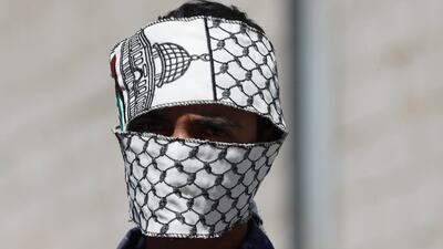 A member of Yemen's Houthi militia covers his face with a Palestinian scarf during a rally in Sanaa this week. EPA