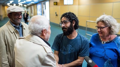 Hassan Al Kontar meets Laurie Cooper, right, and other supporters for his cause after arriving in Vancouver, British Columbia on November 27, 2018. AP