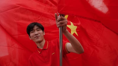 A Chinese man waits for the arrival of President Xi Jinping. AP Photo