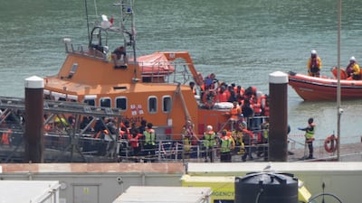 Migrants coming ashore at Dover after being picked up from a small boat in the English Channel. Some can now be returned to France under the new arrangement. PA Wire