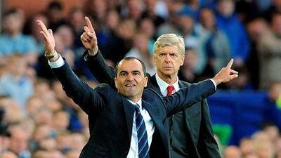 Everton's manager Roberto Martínez, left, and Arsenal's manager Arsene Wenger react during the English Premier League soccer match between Everton and Arsenal at Goodison Park, in Liverpool, England, Saturday, Aug. 23, 2014. (AP Photo/Rui Vieira)