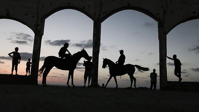 Palestinian youths enjoy the sunset at Bait Lahiya beach, northern Gaza Strip, Palestine. Ali Ali / EPA